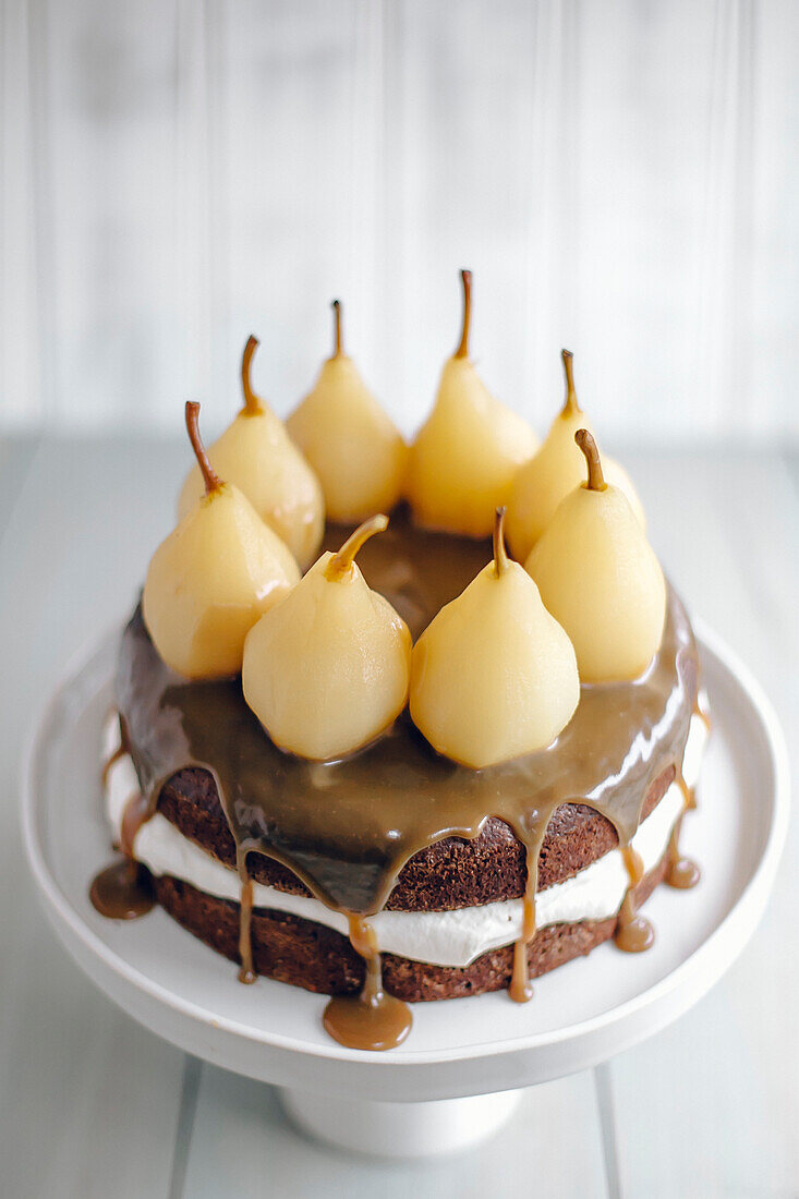 Chocolate cake with caramel sauce and poached pears