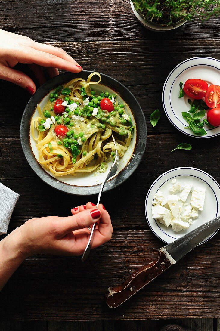 Tagliatelles with, peas, tomatoes, feta and creamy avocado sauce