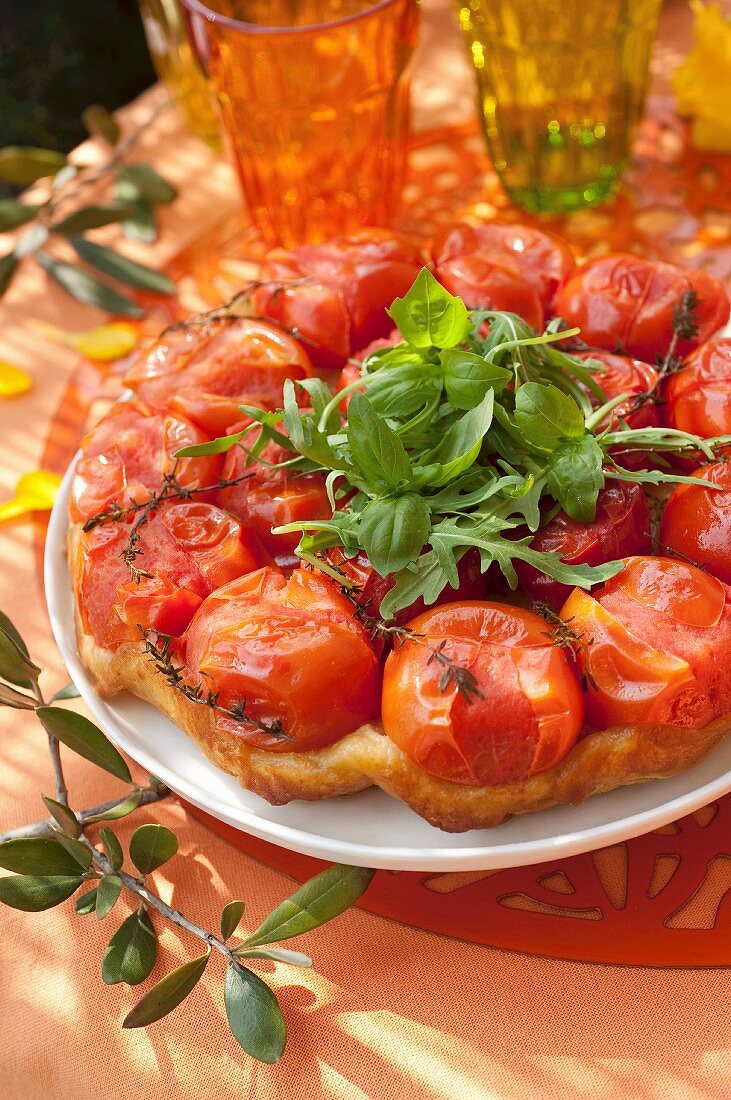 Tomato and thyme tatin tart with rocket lettuce and basil