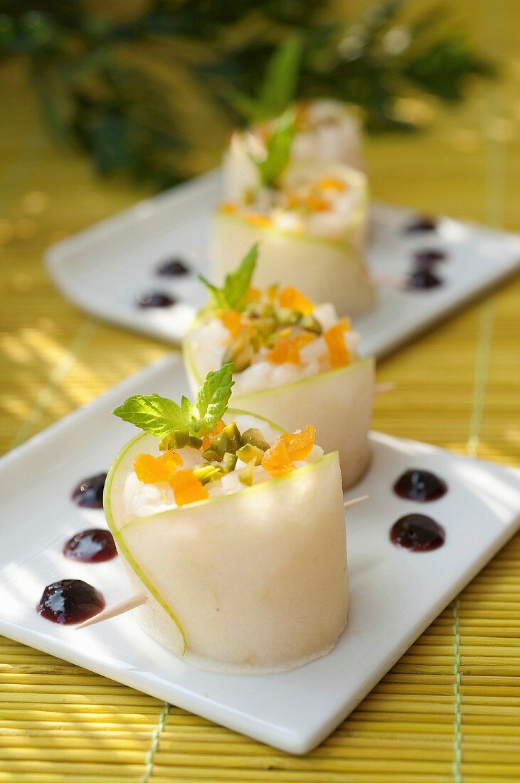 Green apple and fresh goat's cheese makis with crushed pistachios, diced apricots and cherry jam