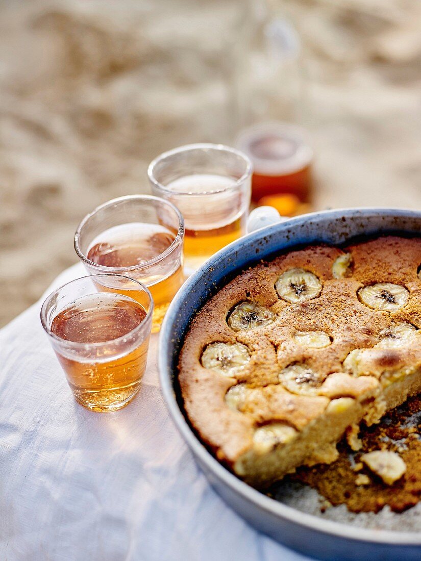 Banana cake and glasses of fizzy apple juice