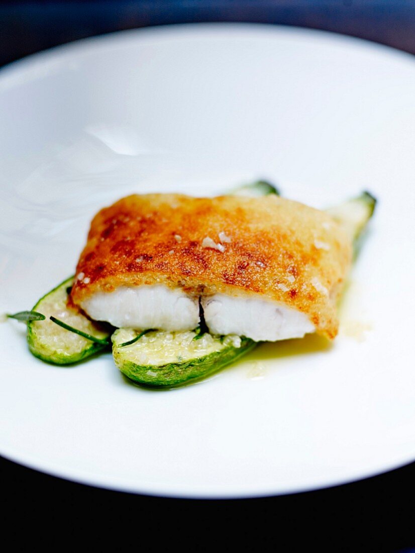 Breaded cod fillet and small flavored courgettes