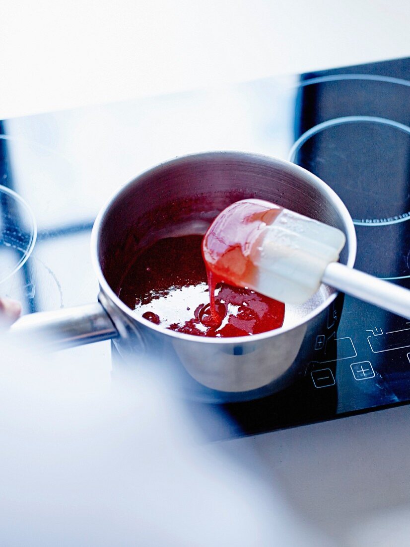 Stirring the preparation off the heat with a rubber spatula to crystallize