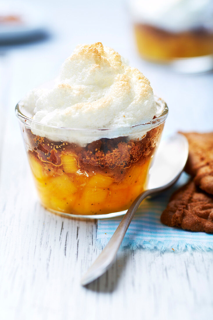 Dessert in a glass with persimmon, speculoos and meringue