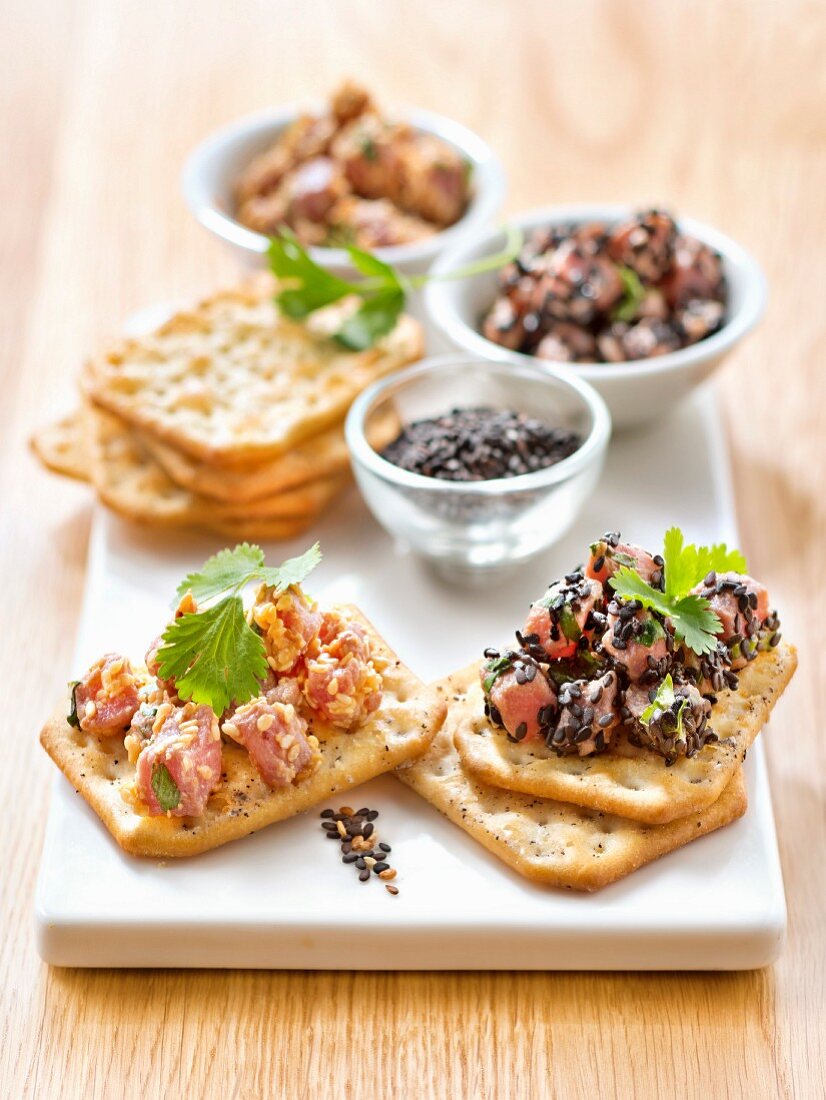 Tuna Tartare With Golden And Black Sesame Seeds On Tuc Aperitif Crackers