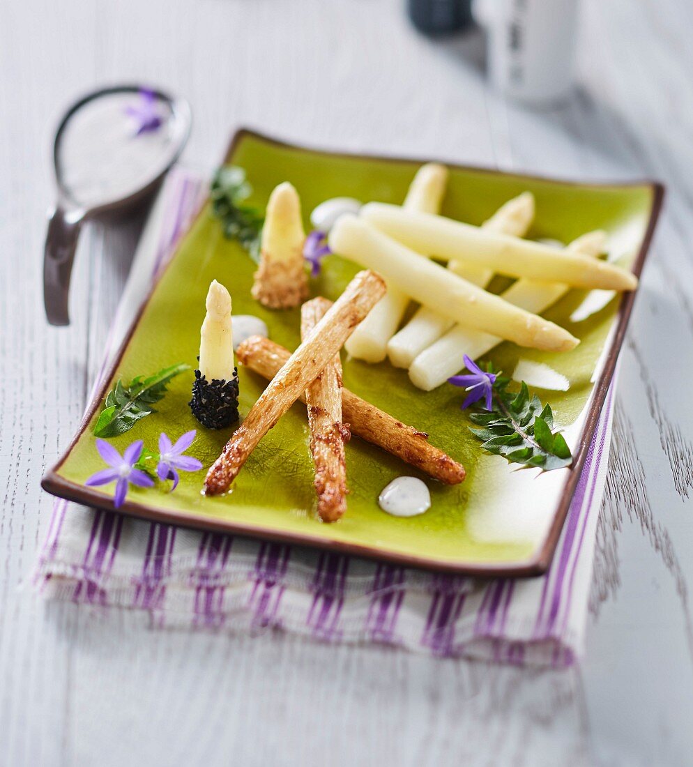 Weisser Spargel zweierlei, gedämpft und gebraten, mit hellen und schwarzen Sesamsamen und Sahne-Minz-Sauce