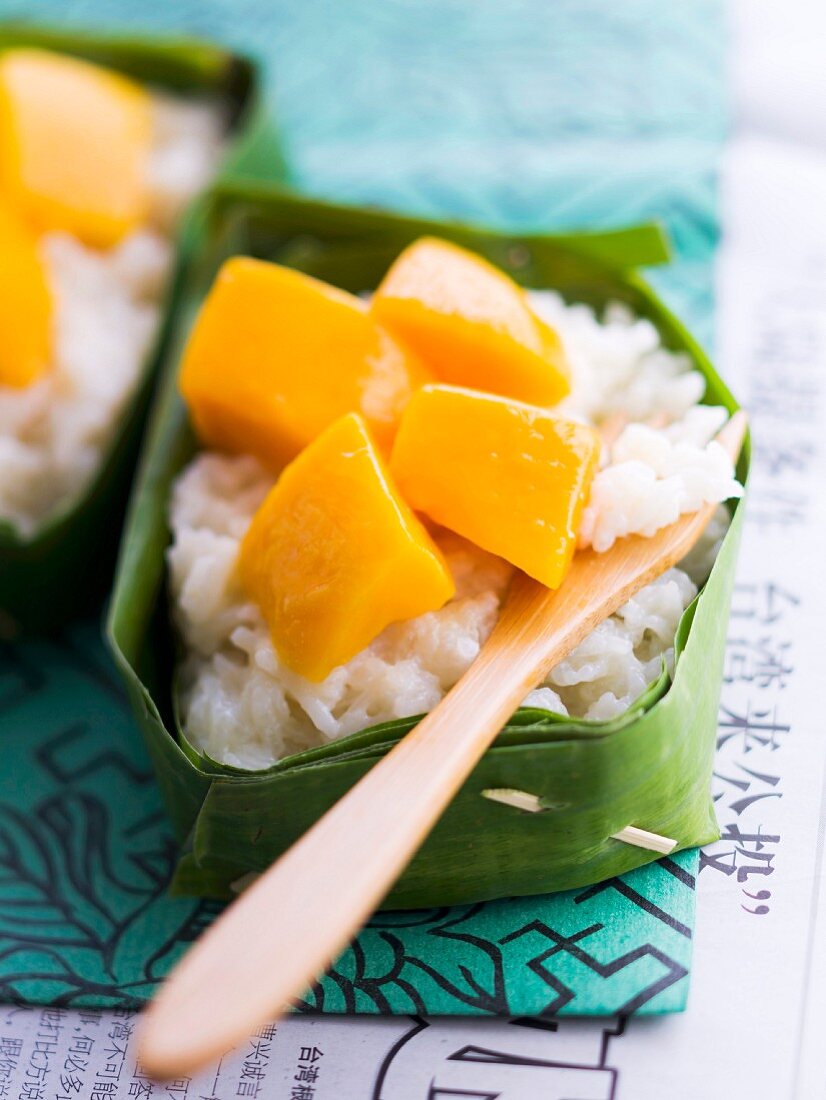 Sticky rice with coconut milk and mango cooked in a banana leaf