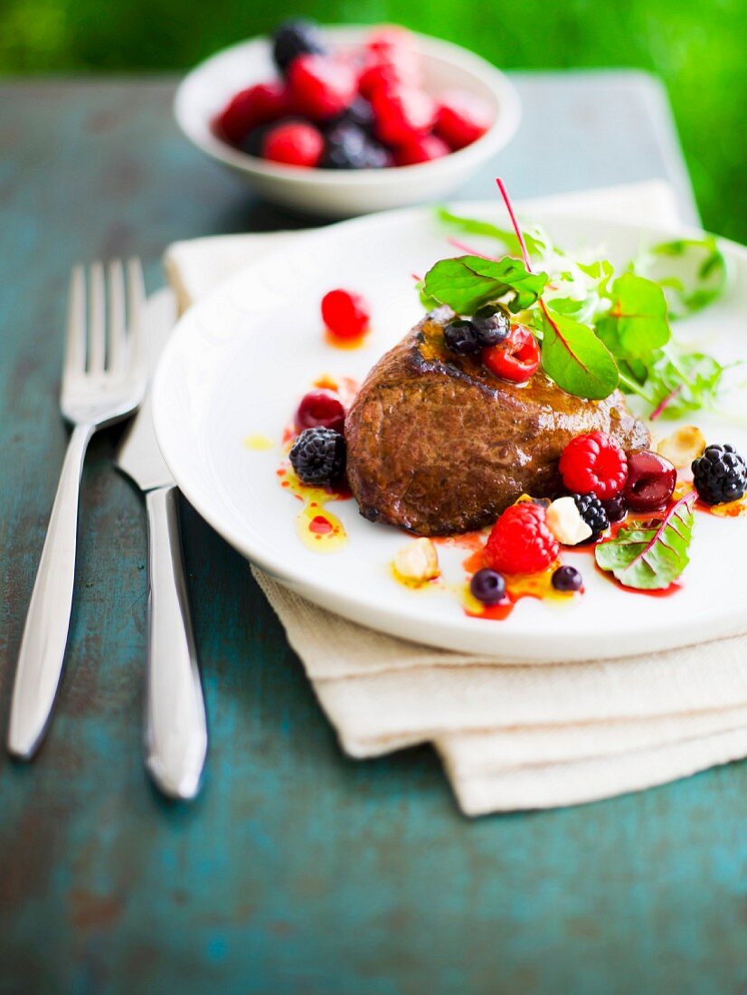 Grilled ostrich fillet with mixed berries and beetroot sprouts