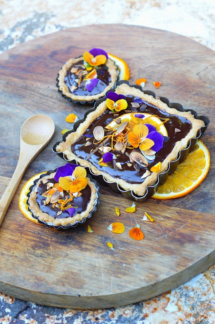 Dark chocolate, almond, pansy and orange tartlets