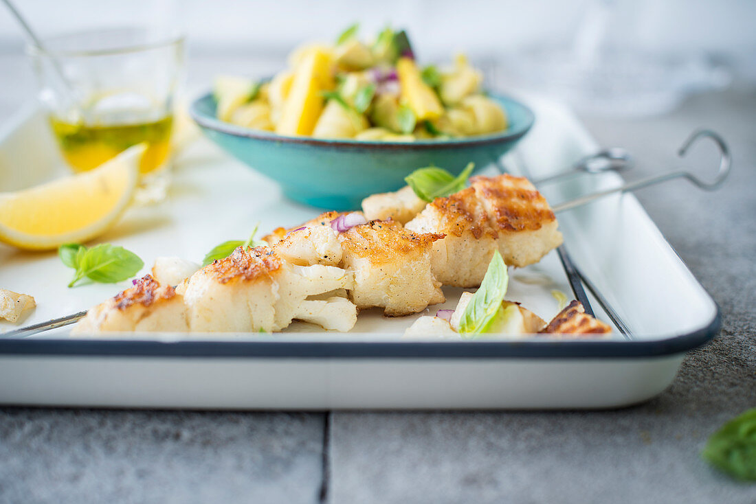 Cod kebabs, pasta salad, mango and avocado