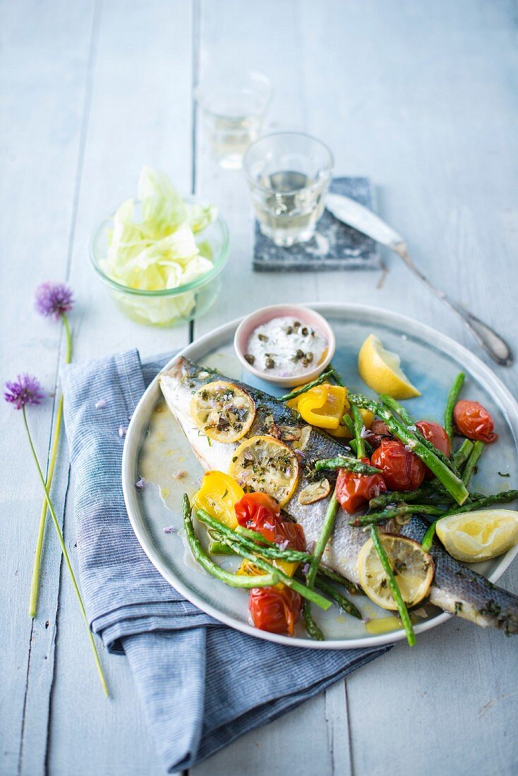 Sea bass with lemon and herbs, grilled vegetables, cream with capers