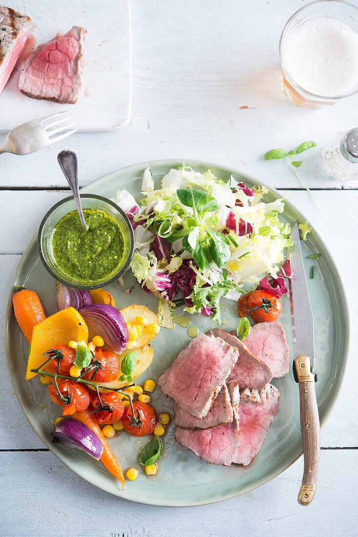 Roast beef with vegetables, mixed leaf salad and pesto