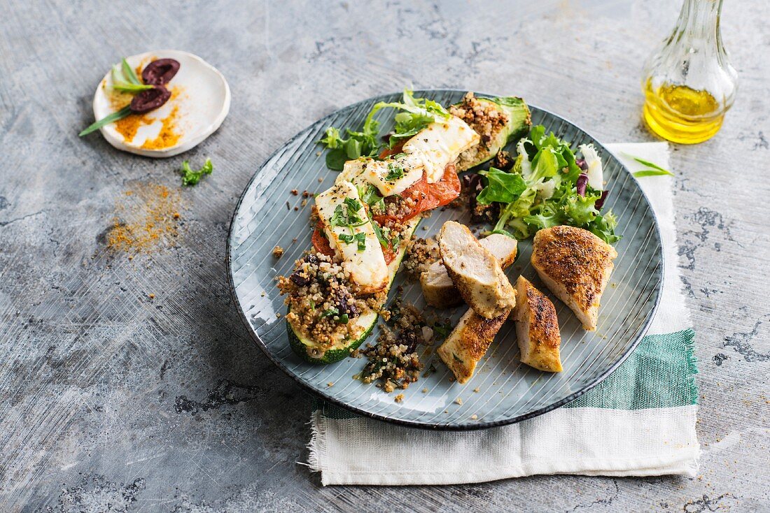 Chicken breast in spicy crust, courgette stuffed with quinoa, tomato and feta