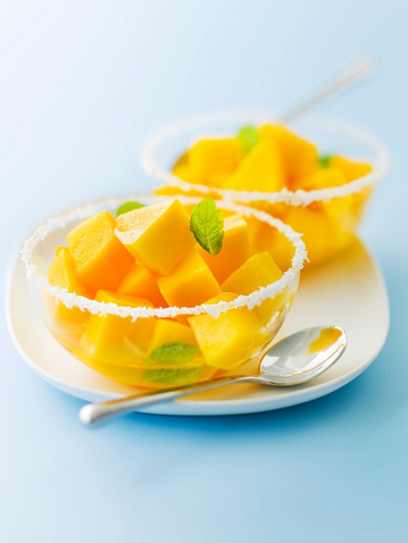 Diced mango fruit salad in mint and coconut syrup
