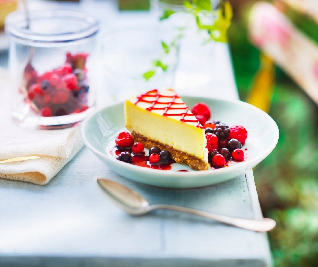 Slice of cheesecake with summer fruit coulis