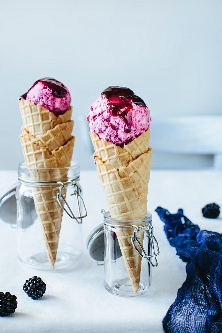 Cones of ice cream cones with blackberry coulis