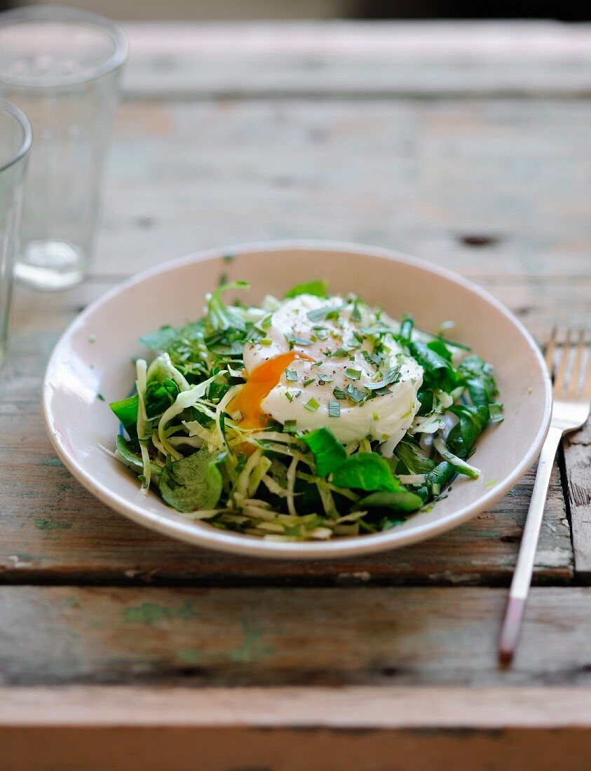 White cabbage and corn lettuce salad with a poached egg