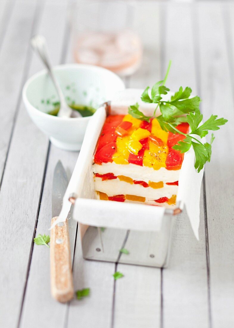 Fromage frais and red and yellow pepper terrine, parsley vinaigrette