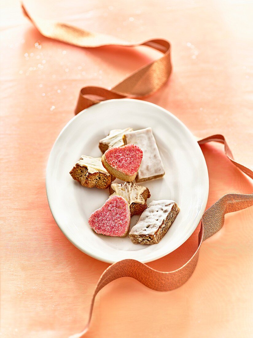 Plate of mixed Christmas biscuits and ribbon