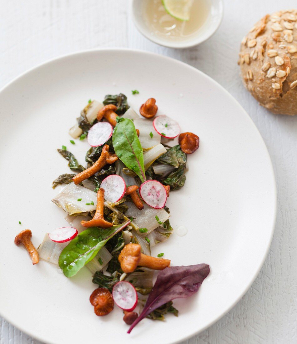 Pan-fried tender Swisschard, chanterelles and thin crisp slices of radishes