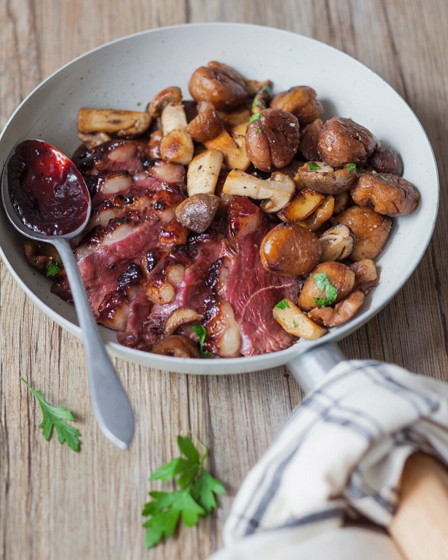 Pan-fried duck fillets with cranberry coulis, mixed mushrooms with chestnuts