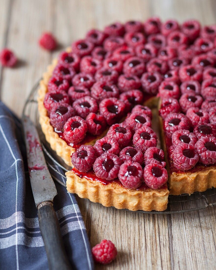 Raspberry tart with red fruit coulis