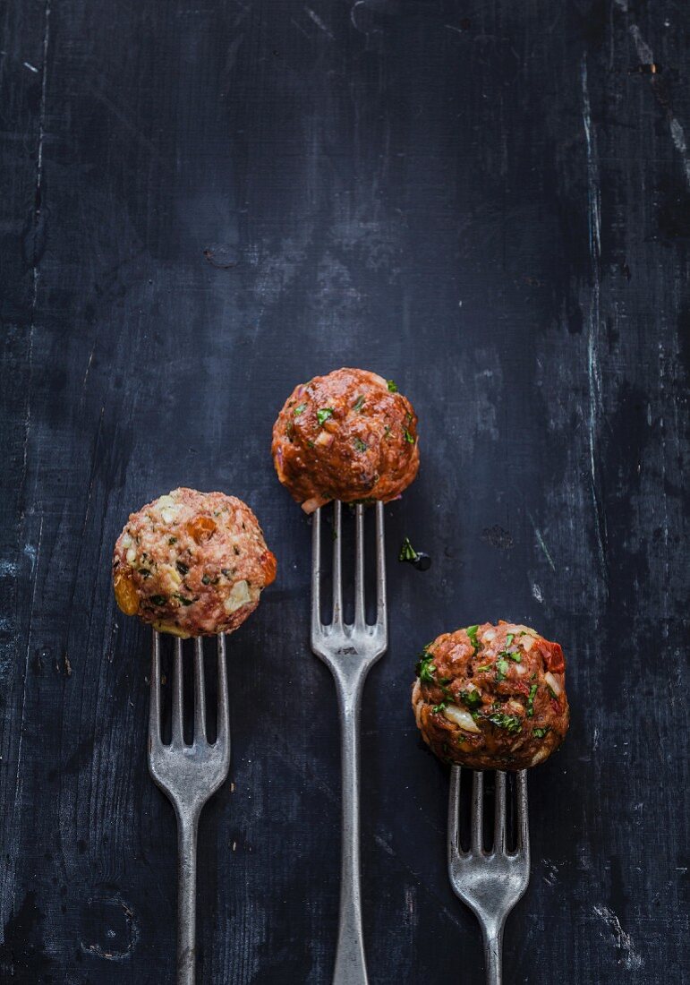 Raw meatball trio on forks