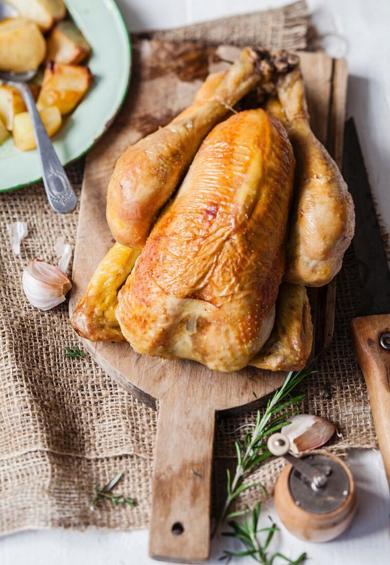 Roasted chicken with thyme, rosemary, garlic and baked potatoes