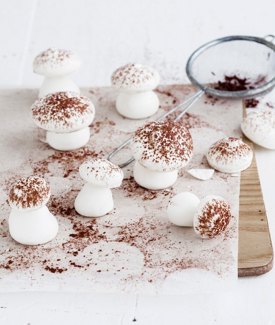 Meringue mushrooms sprinkled with cocoa
