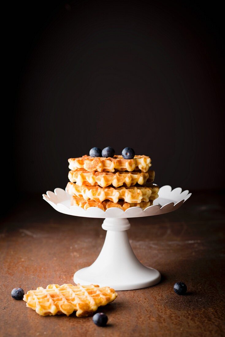 Pile of waffles Liégeoises and blueberries on a presentation dish