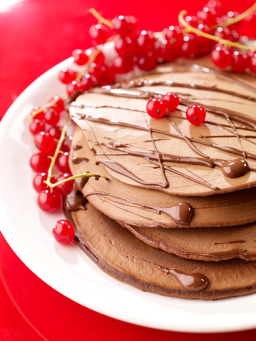 All chocolate pancakes with redcurrants