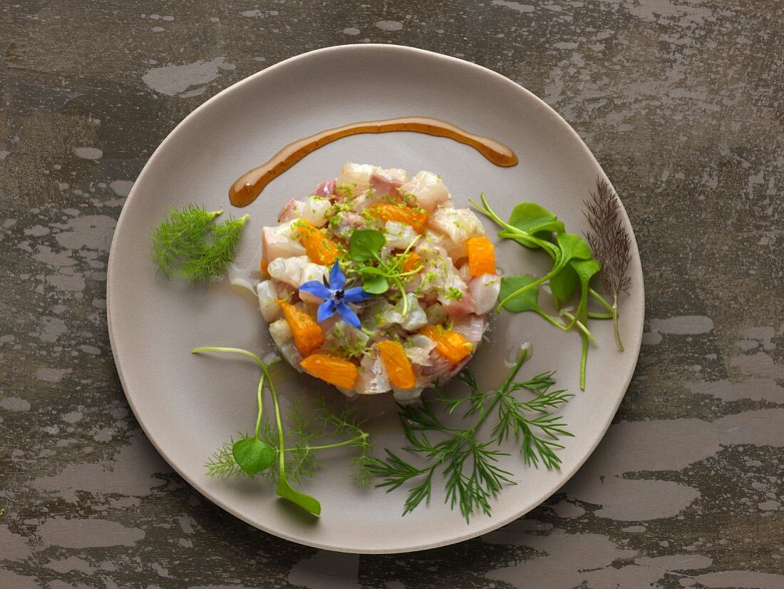 Sea bream tartare with orange, lime zests and borage flowers