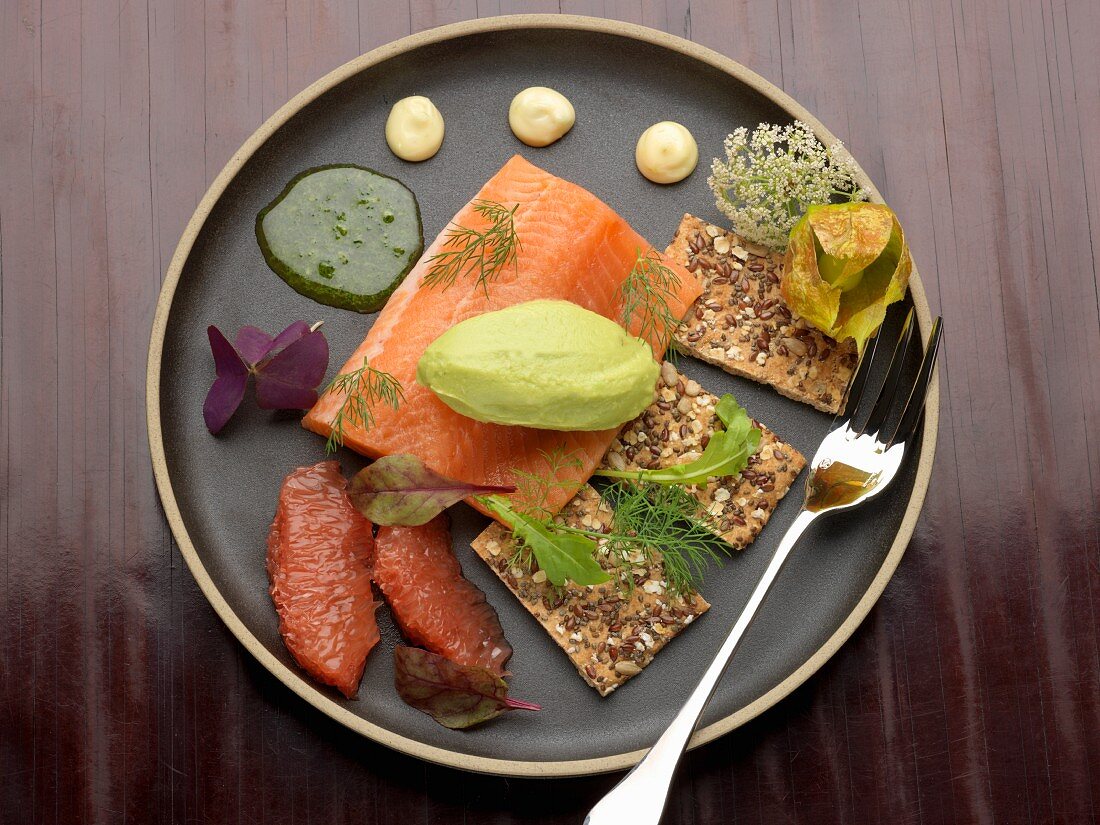 Banka salmon trout, guacamole quenelle, herb vinaigrette, grapefruit segments and seedy crackers