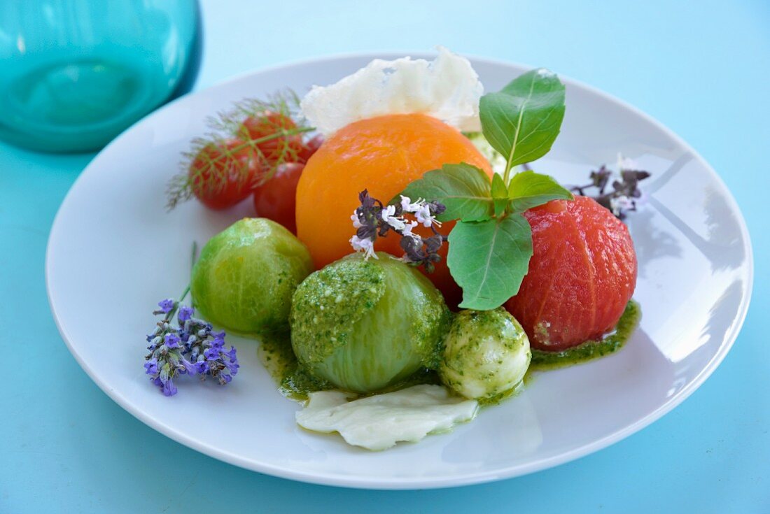 Peeled red, green and yellow tomato salad with mozzarella