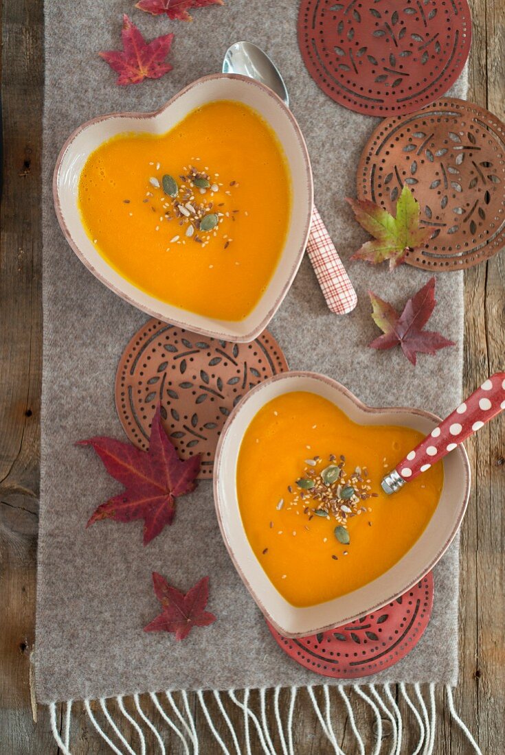 Cream of pumpkin, carrot and orange soup with seeds