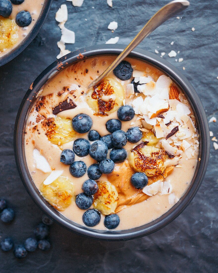 Roasted banana smoothie, chocolate, coconut with peanut butter and blueberries