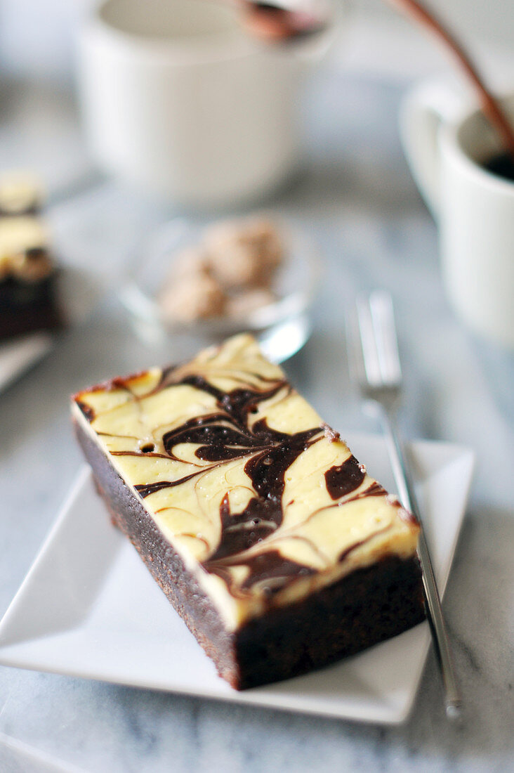 Portion of cheesecake-style brownie and coffee