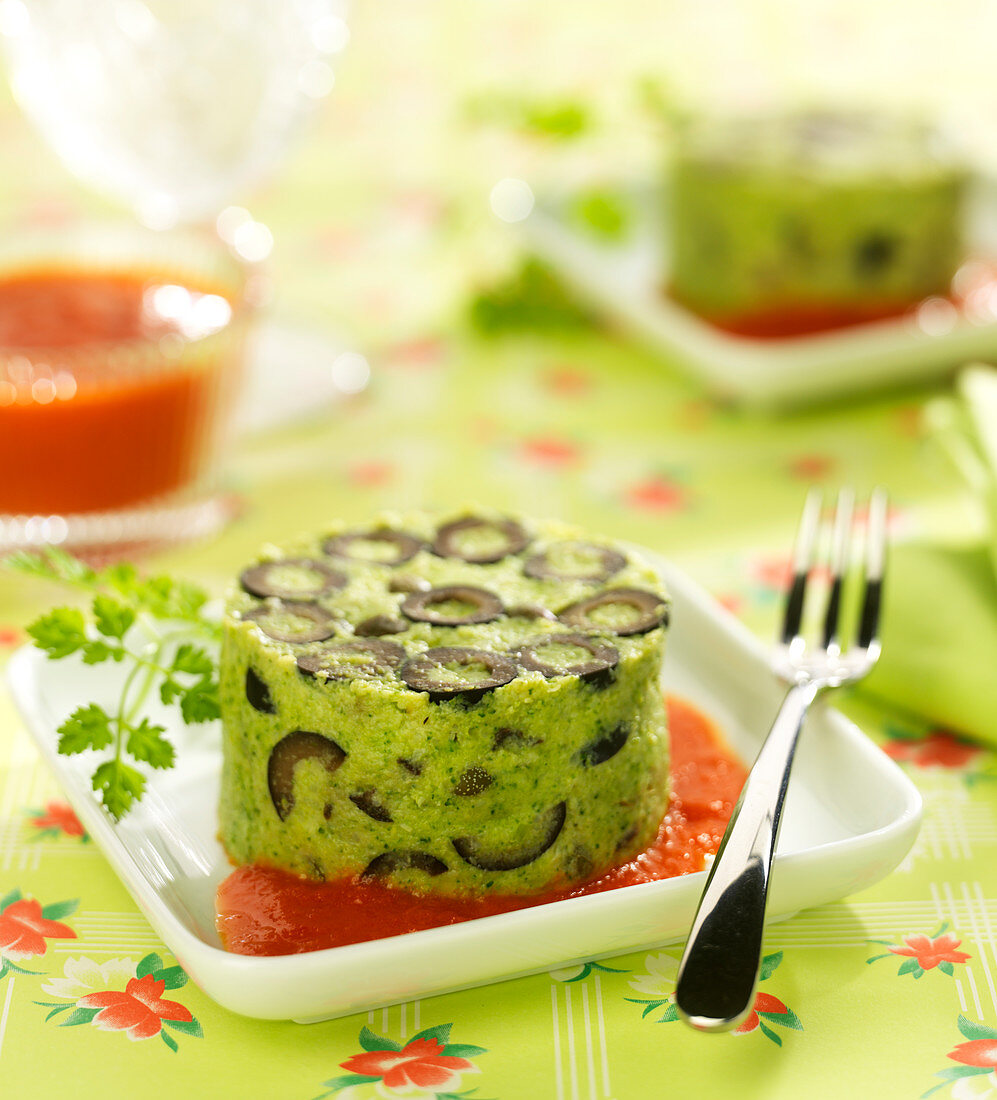 Broccoli mousse with black olives and red pepper coulis