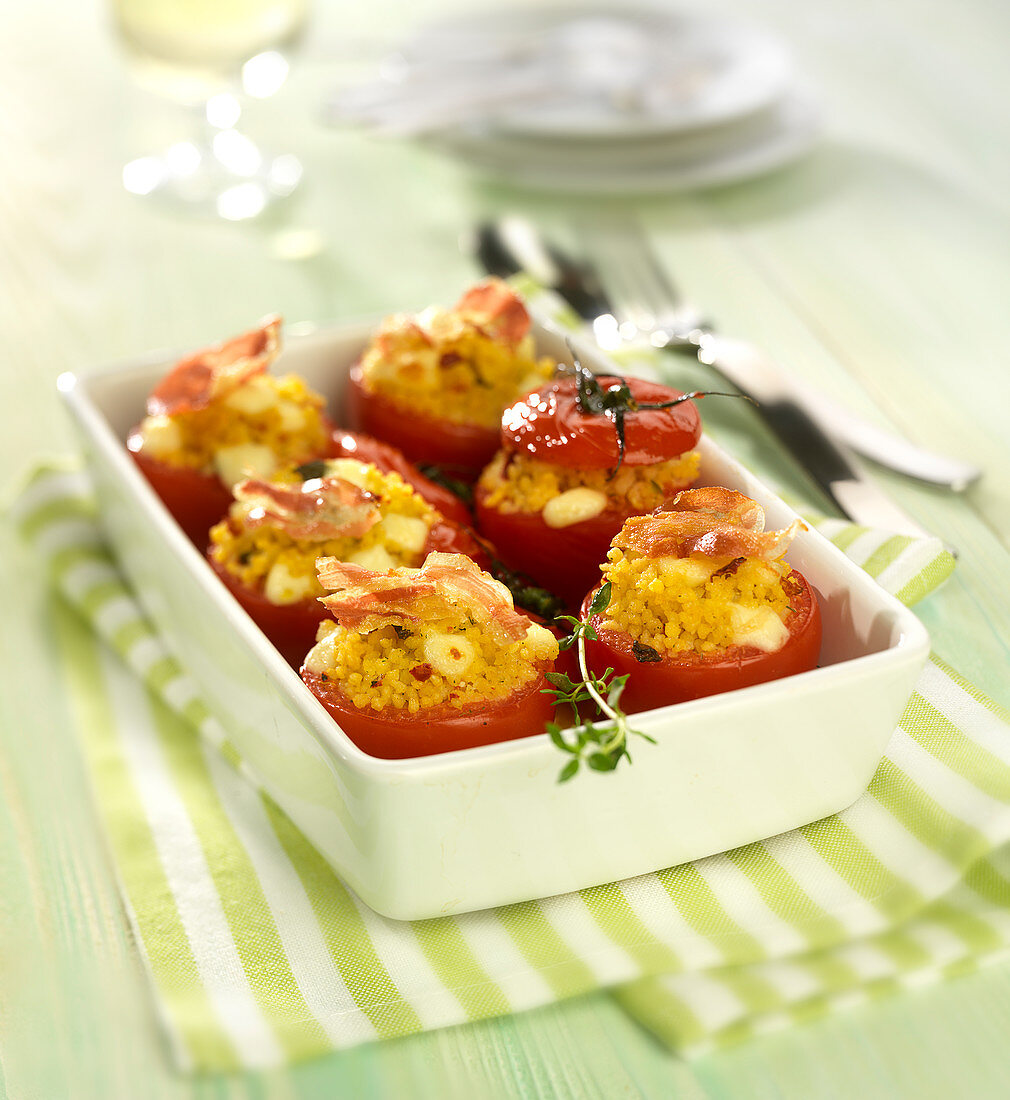 Tomatoes stuffed with corn semolina, mozzarella and pancetta crisps