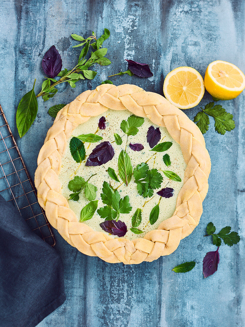 Brousse cheese and herb pie with braided pastry edges