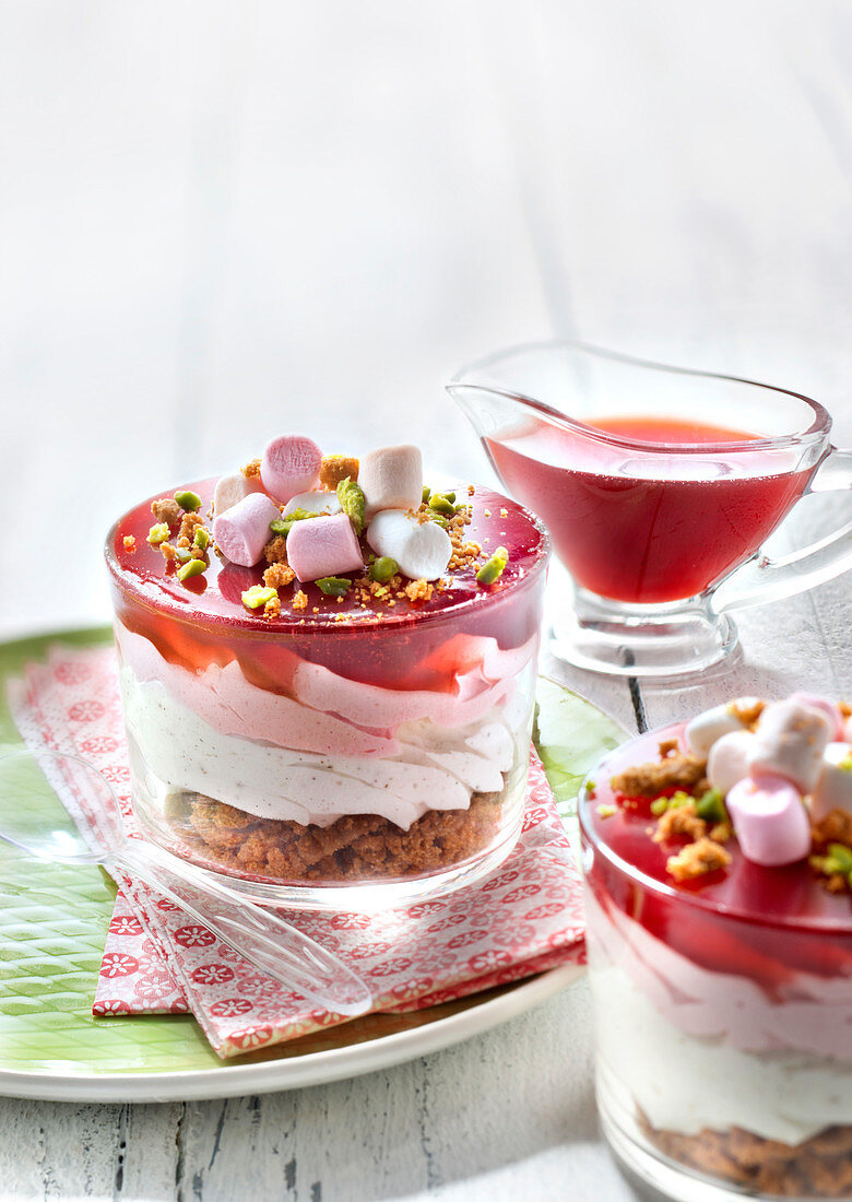 Two-flavored mousses, rose jelly, spicy biscuit crumb,crushed pistachio and marshmallow individual puddings