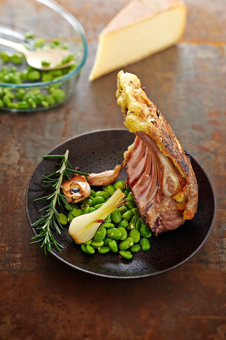 Rack of lamb in Raclette de Savoie crust and broad beans with garlic and spring onions