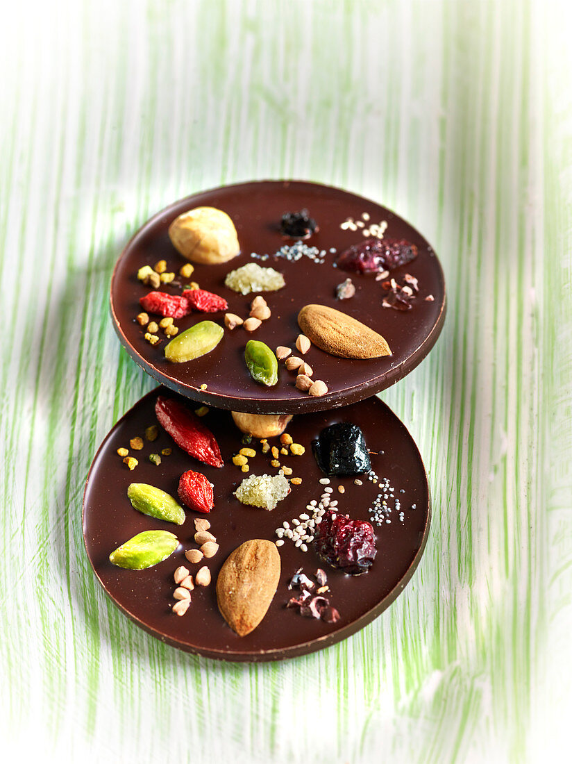 Mendiant-style chocolate Palets with dried fruit, poppy seeds, goji beans,cranberries and sesame seeds