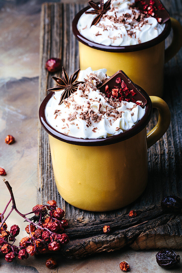 Mugs of spicy hot chocolate topped with whipped cream