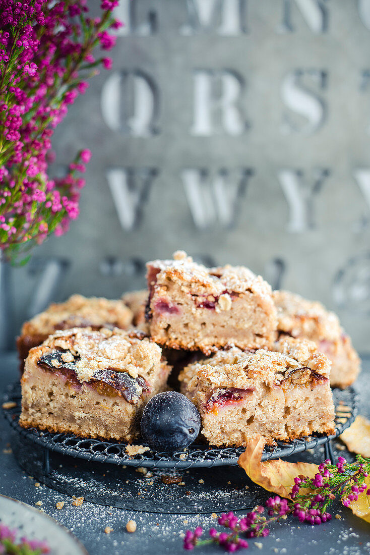 Slices of plums cake and oats crumble topping