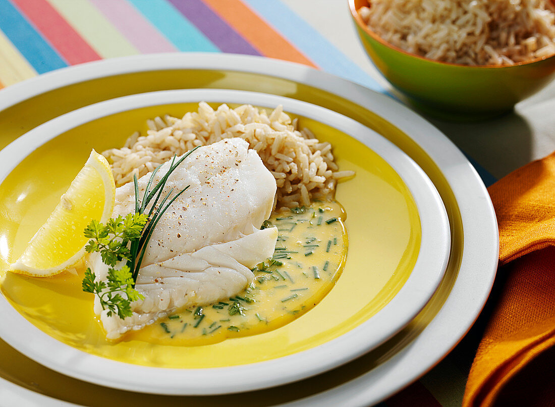 Piece of cod in creamy herb sauce