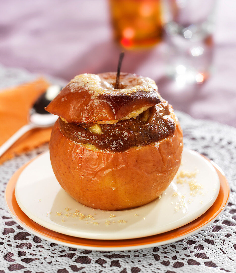 Baked apple garnished with shortbread crumbs, milk jam and crushed hazelnuts