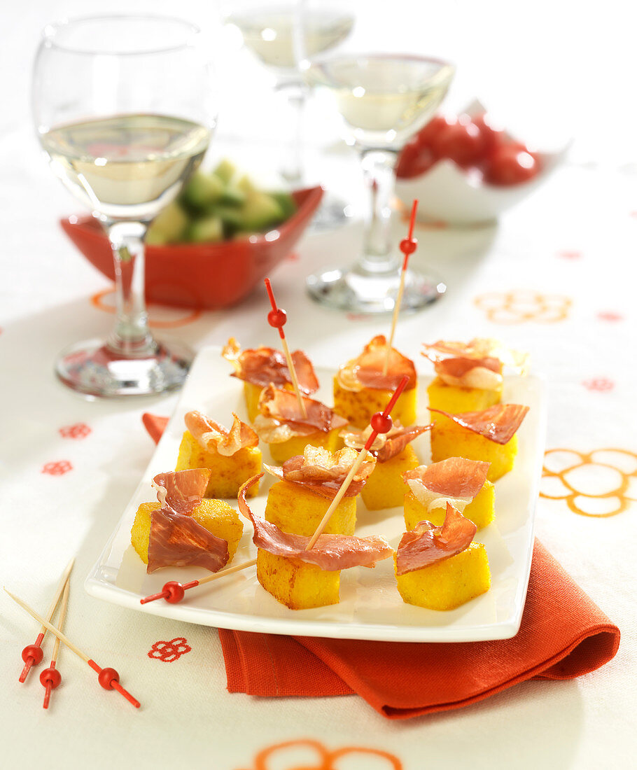 Diced polenta and raw ham appetizers