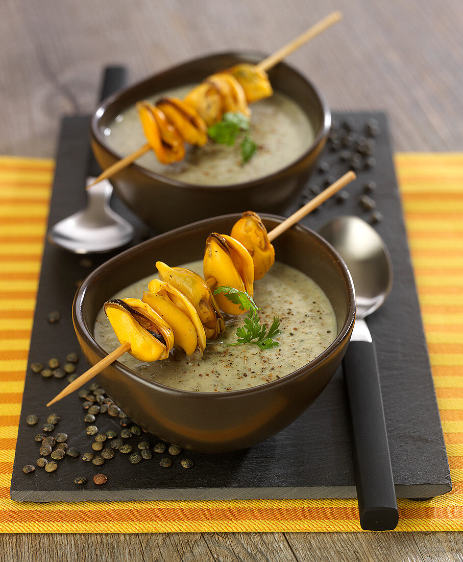 Cream of green lentil soup with mussel brochettes