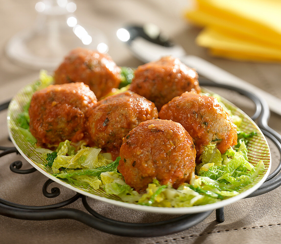 Charolais beef meatballs in tomato sauce with thyme and rosemary,curly cabbage